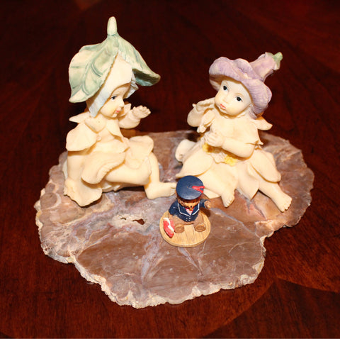 Vintage Garden Fairies Playing with a Bear Toy Sitting on a Slab