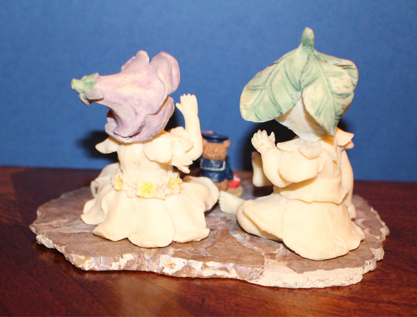 Vintage Garden Fairies Playing with a Bear Toy Sitting on a Slab